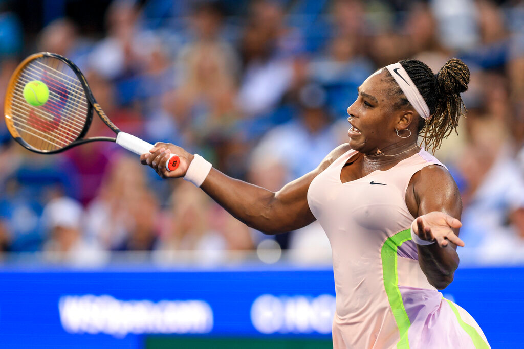 Serena Williams returns a shot to Emma Raducanu, of Britain, during the Western & Southern Open tennis tournament, Tuesday, Aug. 16, 2022, in Mason, Ohio. (AP Photo/Aaron Doster)
