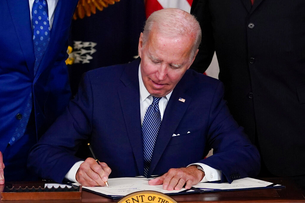 President Joe Biden signs the Democrats' landmark climate change and health care bill in the State Dining Room of the White House in Washington, Tuesday, Aug. 16, 2022. (AP Photo/Susan Walsh)
