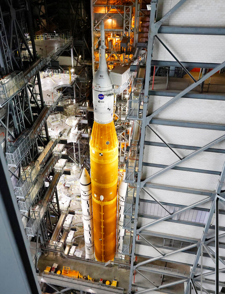 NASA's Artemis rocket, with the Orion spacecraft aboard, stands in the vehicle assembly building before rolling out to launch pad 39B at the Kennedy Space Center, Tuesday, Aug. 16, 2022, in Cape Canaveral, Fla. NASA is aiming for an Aug. 29 liftoff for the lunar test flight. No one will be inside the crew capsule atop the rocket, just three mannequins.   (AP Photo/Terry Renna)