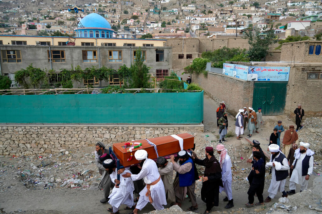 Mourners carry the body of a victim of a mosque bombing in Kabul, Afghanistan, Thursday, Aug. 18. 2022. (AP Photo/Ebrahim Noroozi)