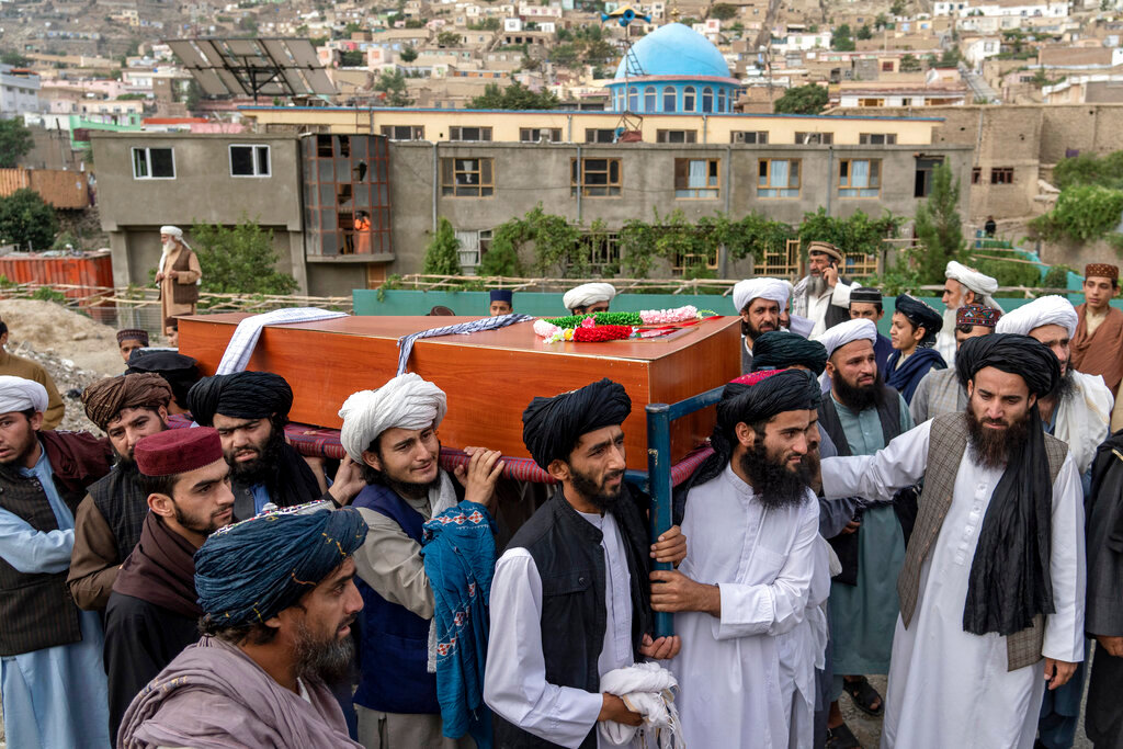 Mourners carry the body of a victim of a mosque bombing in Kabul, Afghanistan, Thursday, Aug. 18. 2022. (AP Photo/Ebrahim Noroozi)