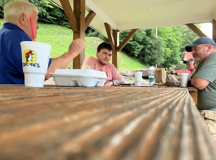 Ronnie Register, left, shares the gospel with fellow diners at Robo's Drive-In restaurant in Pound, Va.