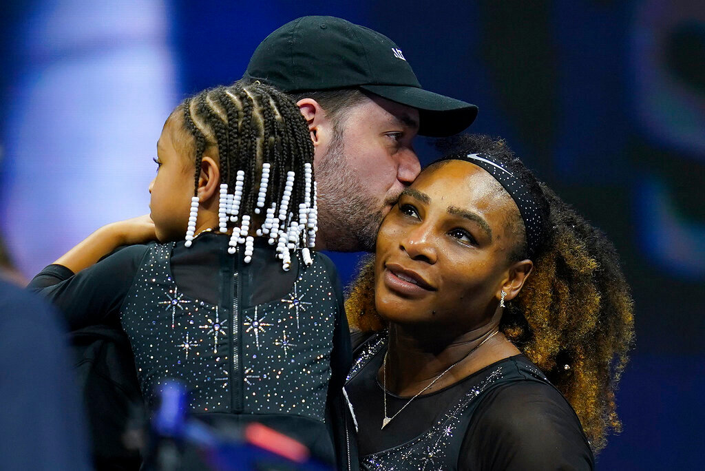 Serena Williams, of the United States, gets a kiss from her husband Alexis Ohanian as their daughter Olympia looks on after Williams defeated Danka Kovinic, of Montenegro, in the first round of the US Open tennis championships, Monday, Aug. 29, 2022, in New York. (AP Photo/Charles Krupa)