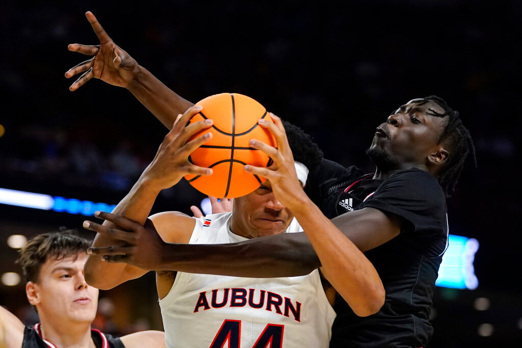 Auburn center Dylan Cardwell drives to the basket past Jacksonville State forward Jay Pal during the second half of a college basketball game in the first round of the NCAA tournament on Friday, March 18, 2022, in Greenville, S.C. (AP Photo/Chris Carlson)