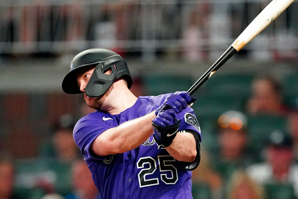 Colorado Rockies' C.J. Cron drives in a run with a base hit during the fourth inning against the Atlanta Braves on Tuesday, Aug. 30, 2022, in Atlanta. (AP Photo/John Bazemore)