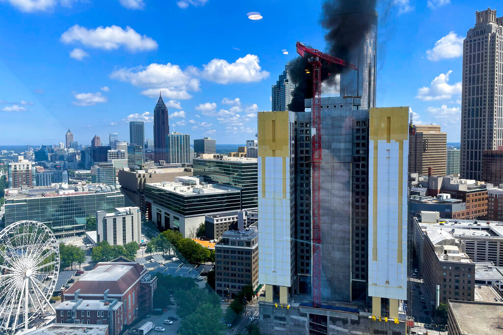 Smoke rises from a building under construction in downtown Atlanta on Wednesday, Aug. 31, 2022. (AP Photo/Mike Warren)