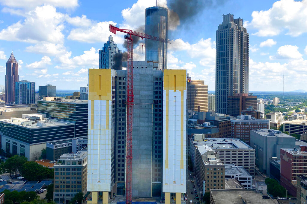 Smoke rises from a building under construction in downtown Atlanta on Wednesday, Aug. 31, 2022. (AP Photo/Alex Sanz)