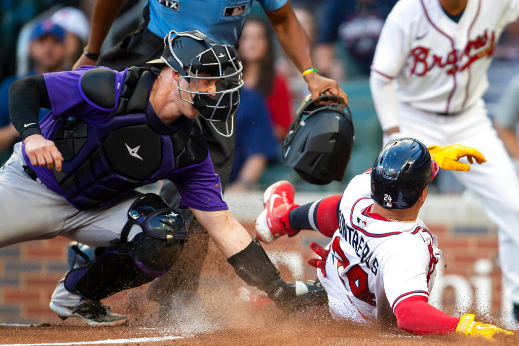 Colorado Rockies catcher Brian Serven left, makes the tag on Atlanta Braves William Contreras right, at home plate in the first inning Wednesday, Aug. 31, 2022, in Atlanta. (AP Photo/Hakim Wright Sr.)