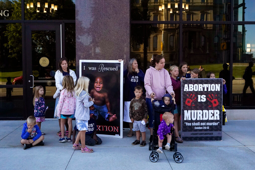 Pro-life supporters gather outside as a hearing of the Michigan Board of State Canvassers, Wednesday, Aug. 31, 2022, in Lansing, Mich. (AP Photo/Carlos Osorio)