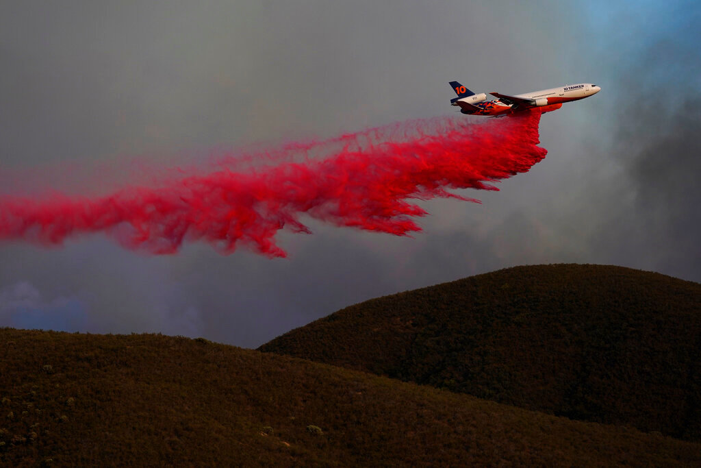 An air tanker drops fire retardant onto the advancing Route Fire Wednesday, Aug. 31, 2022, in Castaic, Calif. (AP Photo/Marcio Jose Sanchez)