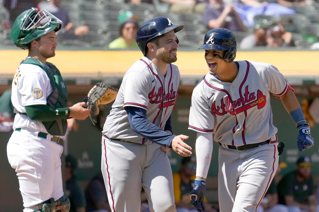 Atlanta Braves' Vaughn Grissom, right, celebrates as he crosses home plate with teammate Travis d'Arnaud, center, after hitting a two-run home run against the Oakland Athletics in Oakland, Calif., Wednesday, Sept. 7, 2022. (AP Photo/Tony Avelar)