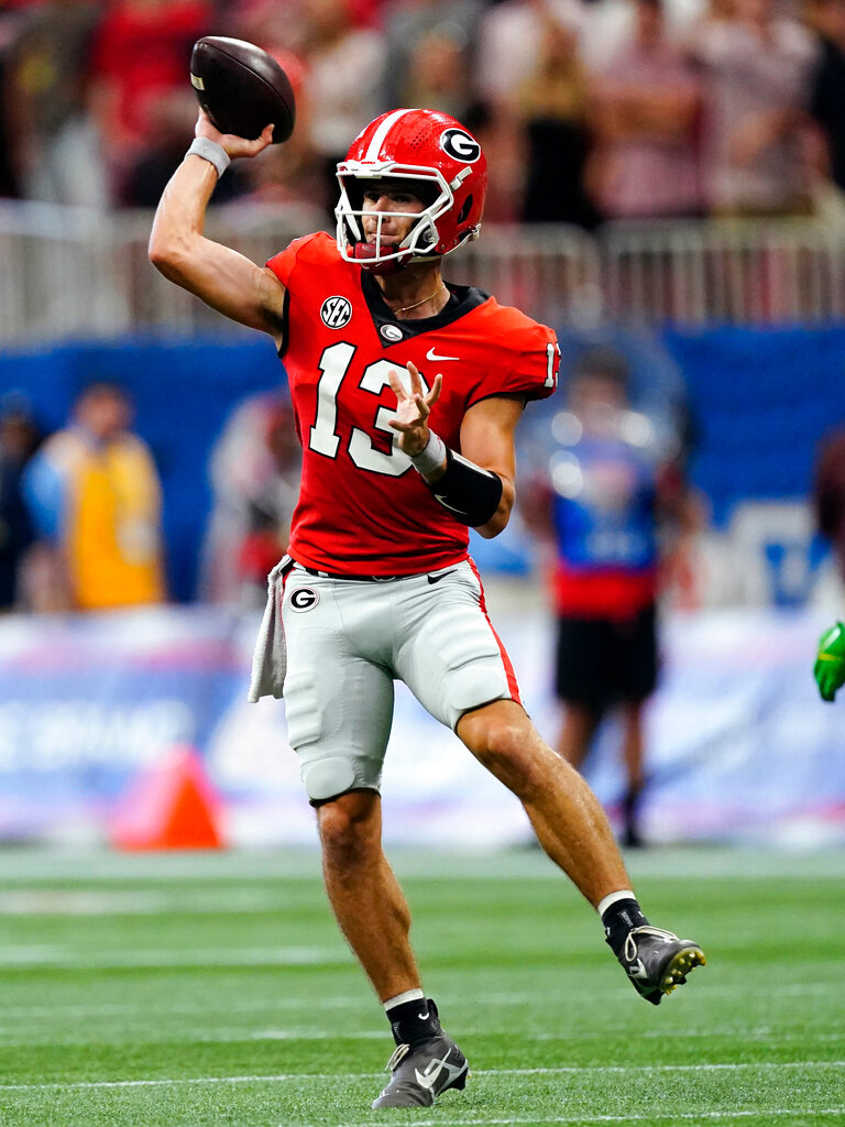 Georgia quarterback Stetson Bennett (13) throws on the run in the first half against Oregon Saturday, Sept. 3, 2022, in Atlanta. (AP Photo/John Bazemore)