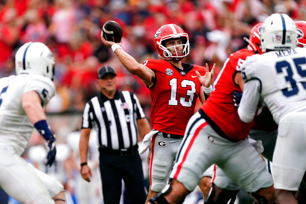 Georgia quarterback Stetson Bennett (13) throws from the pocket during the first half of an NCAA college football game against Samford Saturday, Sept. 10, 2022 in Athens, Ga. (AP Photo/John Bazemore)