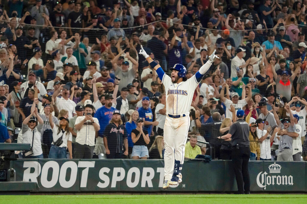 Seattle Mariners' Eugenio Suarez celebrates hitting a walk-off solo home run off Atlanta Braves relief pitcher Kenley Jansen in the ninth inning Sunday, Sept. 11, 2022, in Seattle. The Mariners won 8-7. (AP Photo/Stephen Brashear)