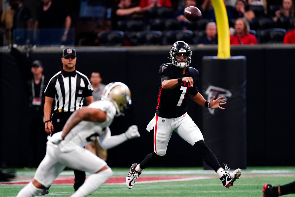 Atlanta Falcons quarterback Marcus Mariota (1) throws the ball on the run against the New Orleans Saints during the first half Sunday, Sept. 11, 2022, in Atlanta. (AP Photo/John Bazemore)