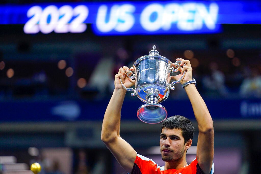 Carlos Alcaraz, of Spain, holds up the championship trophy after defeating Casper Ruud, of Norway, in the men's singles final of the U.S. Open championships Sunday, Sept. 11, 2022, in New York. (AP Photo/Matt Rourke)