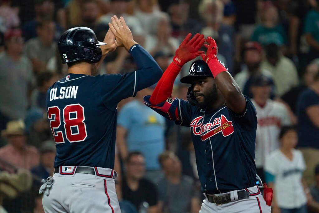 Atlanta Braves' Michael Harris II, right, is congratulated by Matt Olson after hitting a three-run home run off Seattle Mariners relief pitcher Diego Castillo during the ninth inning Sunday, Sept. 11, 2022, in Seattle. (AP Photo/Stephen Brashear)