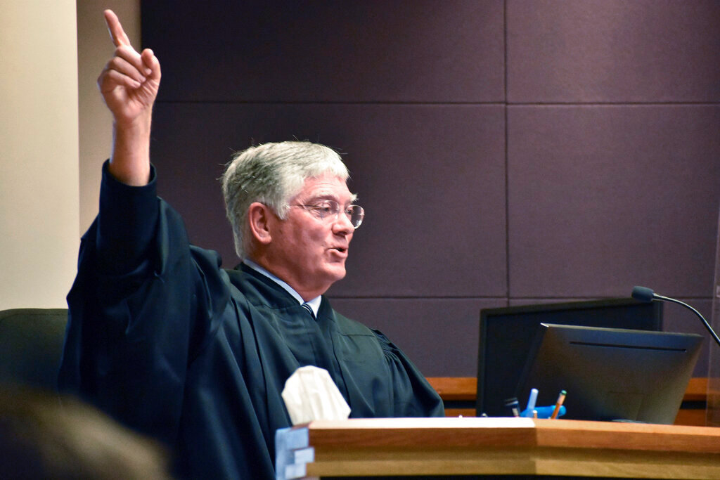 Montana District Judge Michael Moses gestures during a court hearing over a state health department rule that prevents transgender people from changing their birth certificates, Thursday, Sept. 15, 2022, in Billings, Mont. (AP Photos/Matthew Brown)
