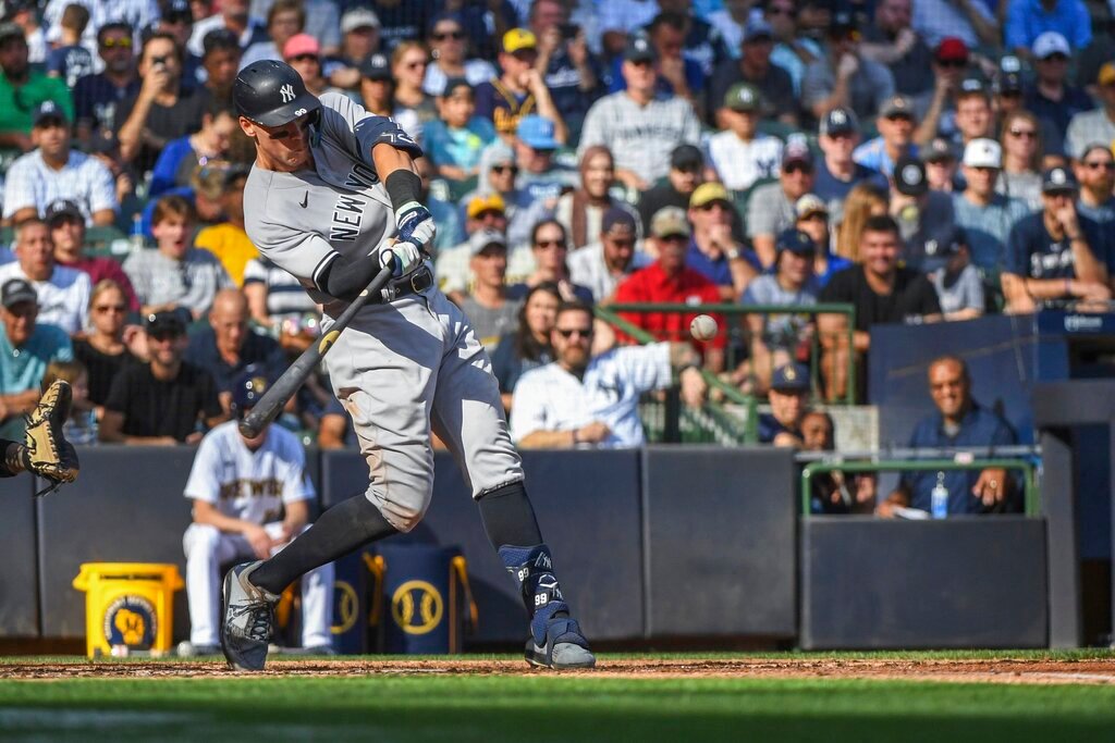 New York Yankees' Aaron Judge hits his 59th home run during the seventh inning against the Milwaukee Brewers, Sunday, Sept. 18, 2022, in Milwaukee. (AP Photo/Kenny Yoo)