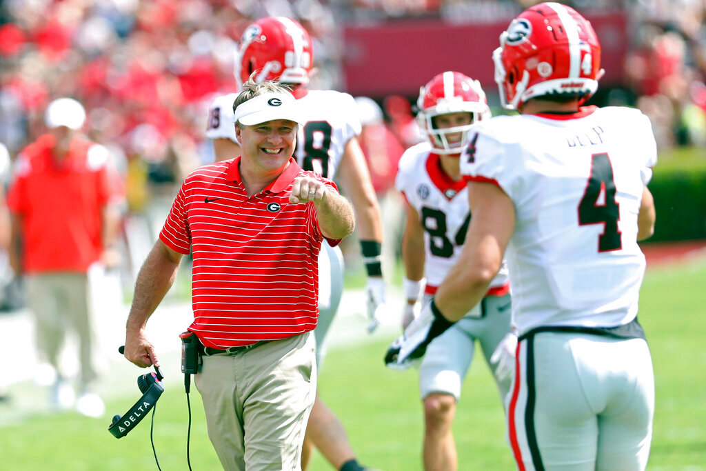Georgia head coach Kirby Smart congratulates tight end Oscar Delp (4) after he scored a touchdown during the second half against South Carolina on Saturday, Sept. 17, 2022, in Columbia, S.C. (AP Photo/Artie Walker Jr.)