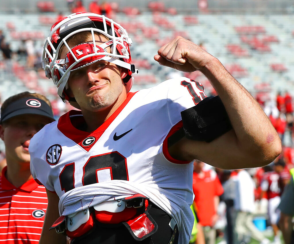 Georgia tight end Brock Bowers, who scored three touchdowns in the game, pumps his fist at cheering Georgia fans as he walks off the field following a 48-7 victory over South Carolina on Saturday, Sept. 17, 2022, in Columbia, S.C.  (Curtis Compton/Atlanta Journal-Constitution via AP)