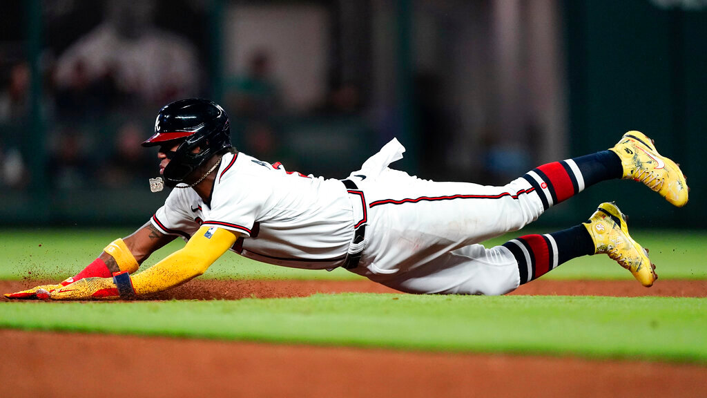 Atlanta Braves' Ronald Acuna Jr. slides into second base on an unsuccessful steal-attempt in the third inning against the Washington Nationals, Monday, Sept. 19, 2022, in Atlanta. (AP Photo/John Bazemore)