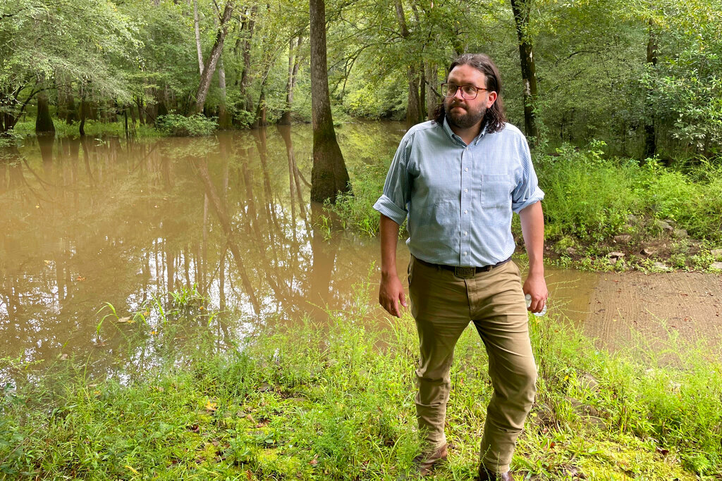 Seth Clark, mayor pro-tem of Macon, walks in the Bond Swamp National Wildlife Refuge in Round Oak, Ga., on Aug. 22, 2022. (AP Photo/Michael Warren)