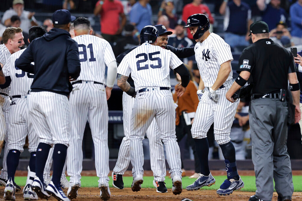 New York Yankees' Giancarlo Stanton celebrates with teammates, including Gleyber Torres (25), after hitting a game-winning grand slam against the Pittsburgh Pirates, Tuesday, Sept. 20, 2022, in New York. (AP Photo/Jessie Alcheh)