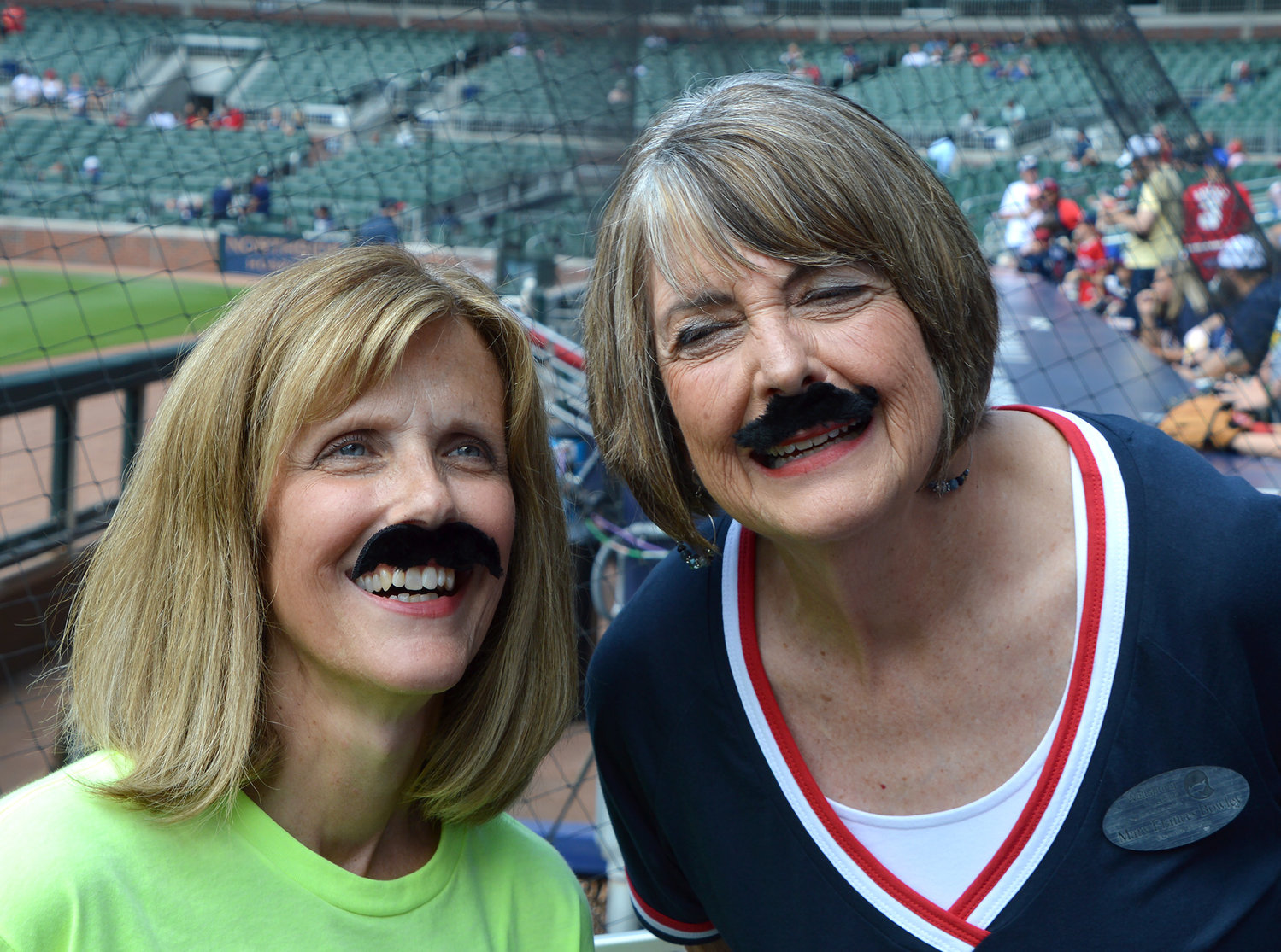 Georgia Baptist Mission Board strategist Beth Ann Williams and Mary Frances Bowley, right, executive director of Wellspring Living, wear mustaches in honor of Atlanta Braves starting pitcher Spencer Strider, prior to the Braves game Sunday, Sept. 18, 2022, in Atlanta. Representatives from Mission Georgia were at the game to promote Wellspring Living, which provides housing to survivors of human trafficking, prior to the Atlanta Braves game Sunday, Sept. 18, 2022, in Atlanta. (Christian Index/Henry Durand)