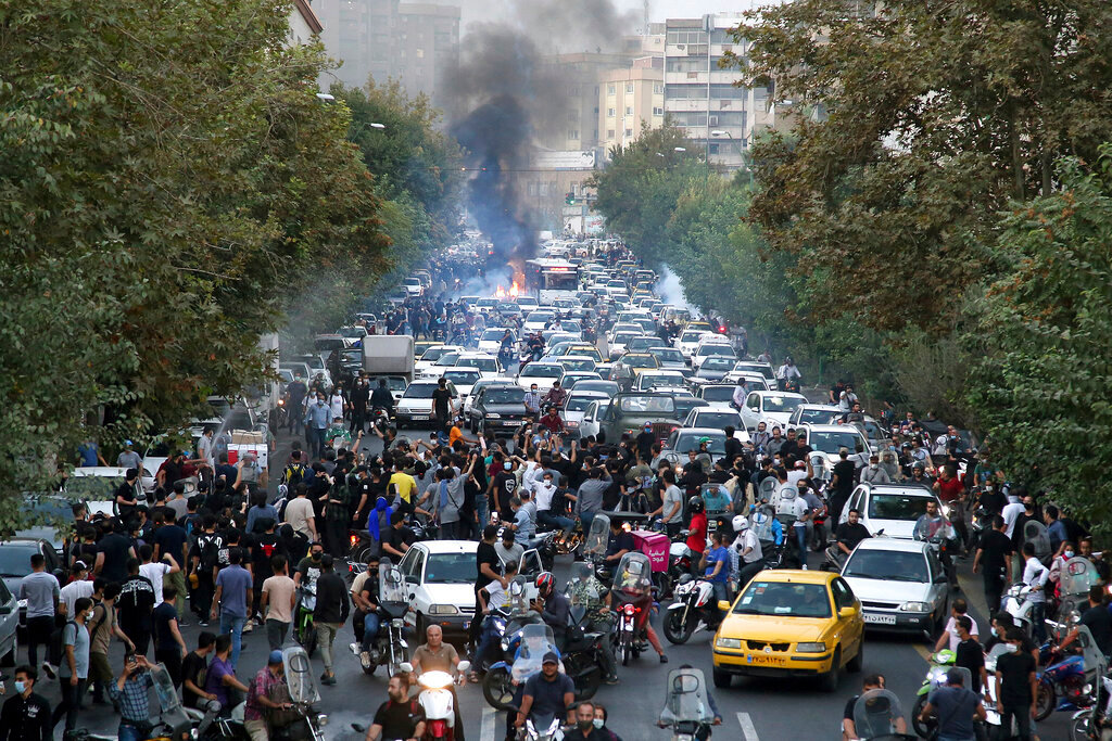 Protesters chant slogans during a protest over the death of a woman who was detained by the morality police, in downtown Tehran, Iran, Wednesday, Sept. 21, 2022. (AP Photo)