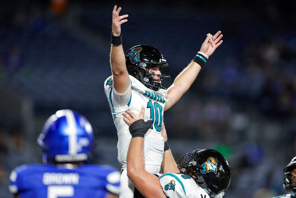 Coastal Carolina quarterback Grayson McCall (10) is lifted in the air by offensive lineman Will McDonald, bottom, after scoring a touchdown during the first half against Georgia State on Thursday, Sept. 22, 2022, in Atlanta. (AP Photo/Stew Milne)
