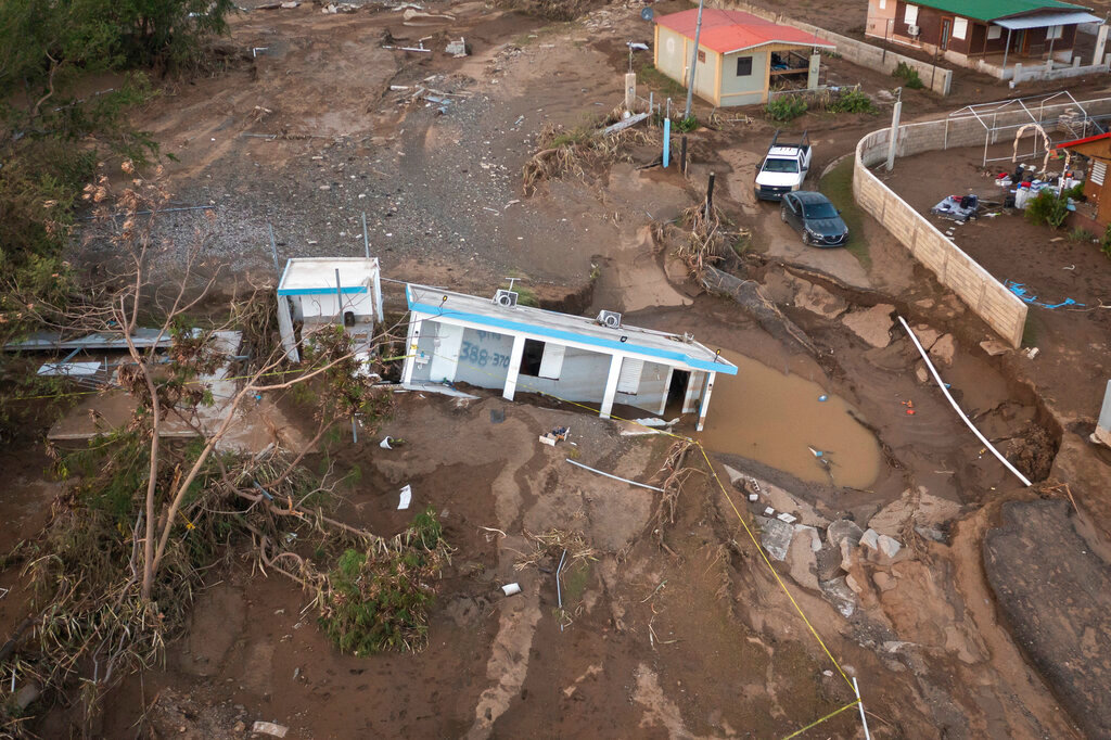 A house sits in mud after it was washed away by Hurricane Fiona at Villa Esperanza in Salinas, Puerto Rico, Wednesday, Sept. 21, 2022. (AP Photo/Alejandro Granadillo)