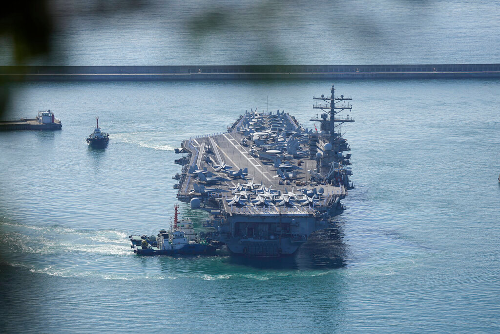 U.S. aircraft carrier USS Ronald Reagan is escorted into Busan Naval Base in Busan, South Korea, Friday, Sept. 23, 2022. (AP Photo/Lee Jin-man)