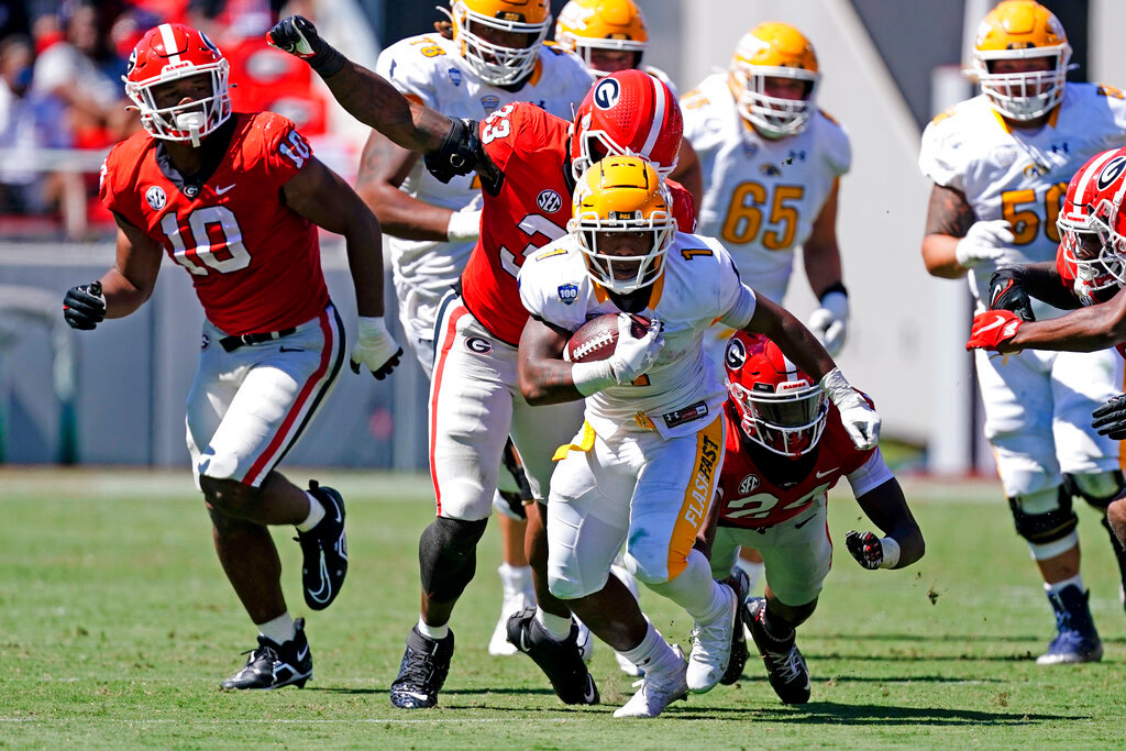 Kent State running back Marquez Cooper (1) runs the ball past Georgia defenders Robert Beal Jr. (33) and Malaki Starks (24) in the second half Saturday, Sept. 24, 2022, in Athens, Ga. (AP Photo/John Bazemore)