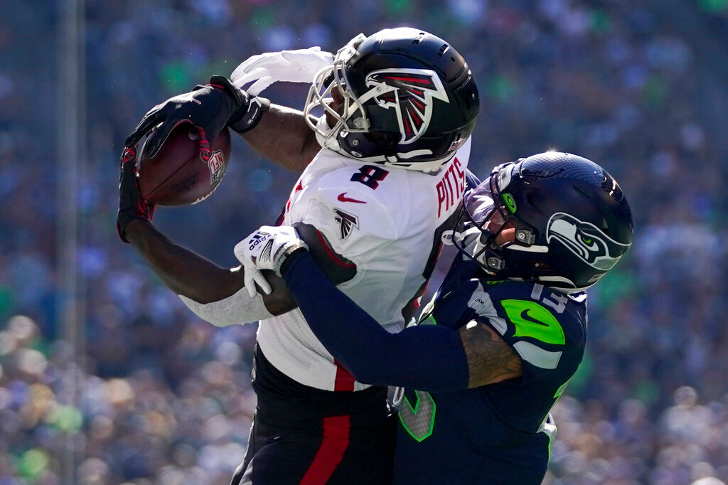 Atlanta Falcons tight end Kyle Pitts hauls in a pass as Seattle Seahawks safety Josh Jones defends during the first half Sunday, Sept. 25, 2022, in Seattle. (AP Photo/Ashley Landis)