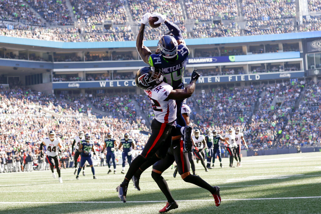 Seattle Seahawks wide receiver DK Metcalf, above, makes a catch in the end zone for a touchdown as Atlanta Falcons safety Jaylinn Hawkins defends during the first half Sunday, Sept. 25, 2022, in Seattle. (AP Photo/John Froschauer)