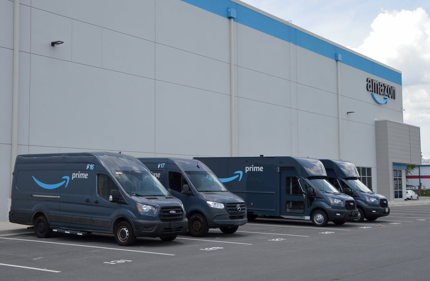 Amazon Prime delivery vehicles sit parked outside a distribution center in Doraville, Ga., July 27, 2022. (Christian Index/Henry Durand, File)