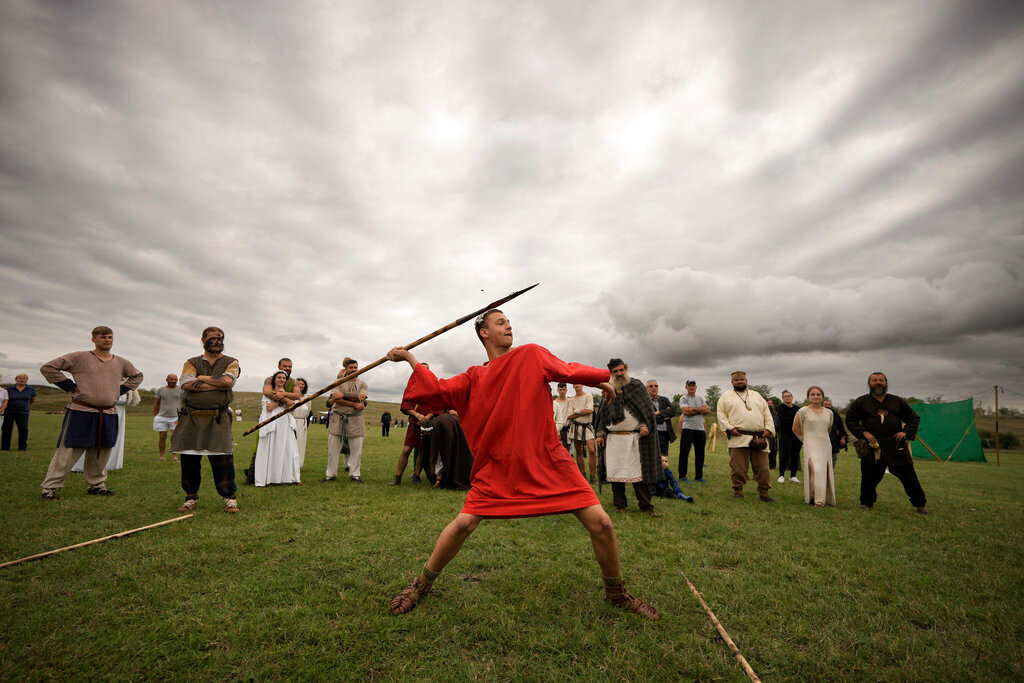 A man throws a spear during an ancient sports competition during the Romula Fest historic reenactment festival in the village of Resca, Romania, Saturday, Sept. 3, 2022. (AP Photo/Andreea Alexandru)