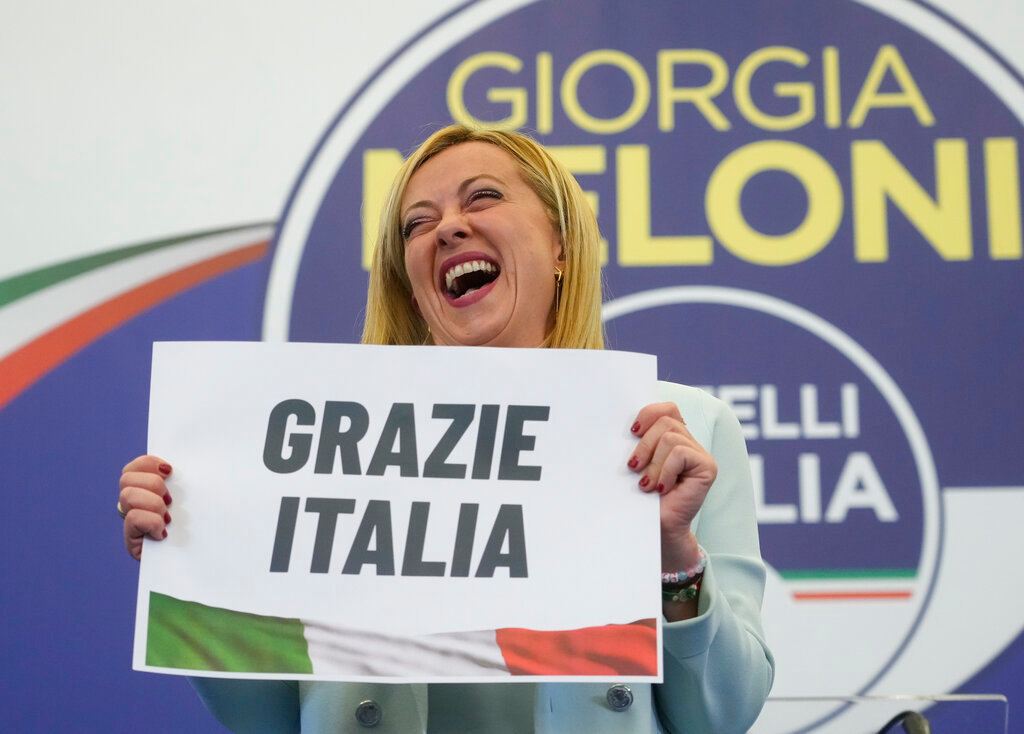 Brothers of Italy's leader Giorgia Meloni shows a placard reading in Italian "Thank you Italy" at her party's electoral headquarters in Rome, early Monday, Sept. 26, 2022. (AP Photo/Gregorio Borgia)