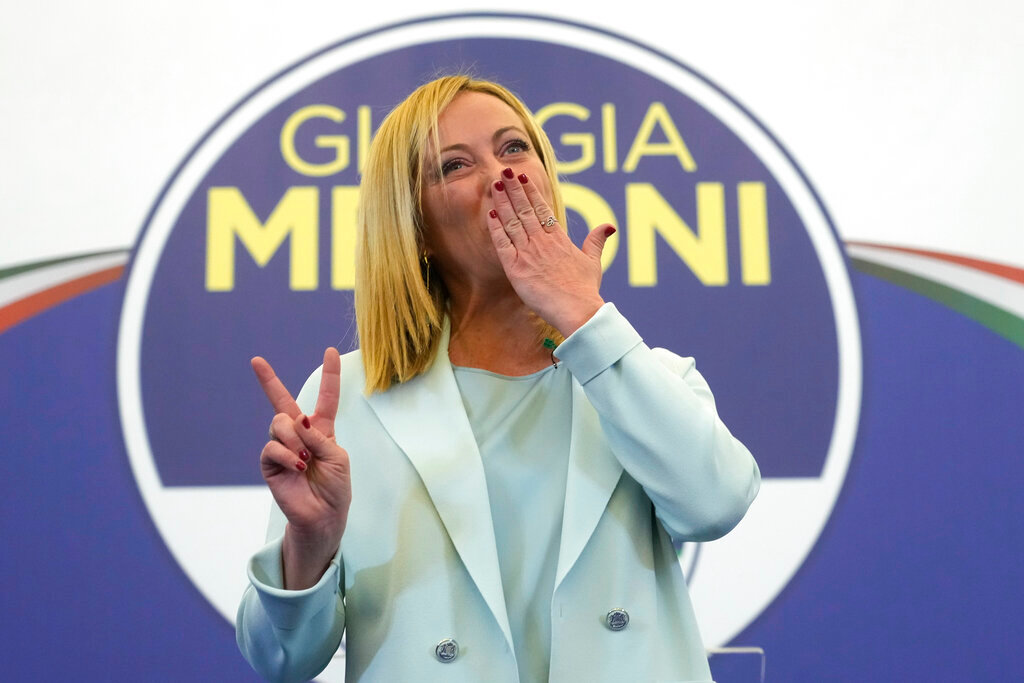 Brothers of Italy's leader Giorgia Meloni flashes the victory sign at her party's electoral headquarters in Rome, early Monday, Sept. 26, 2022. (AP Photo/Gregorio Borgia)