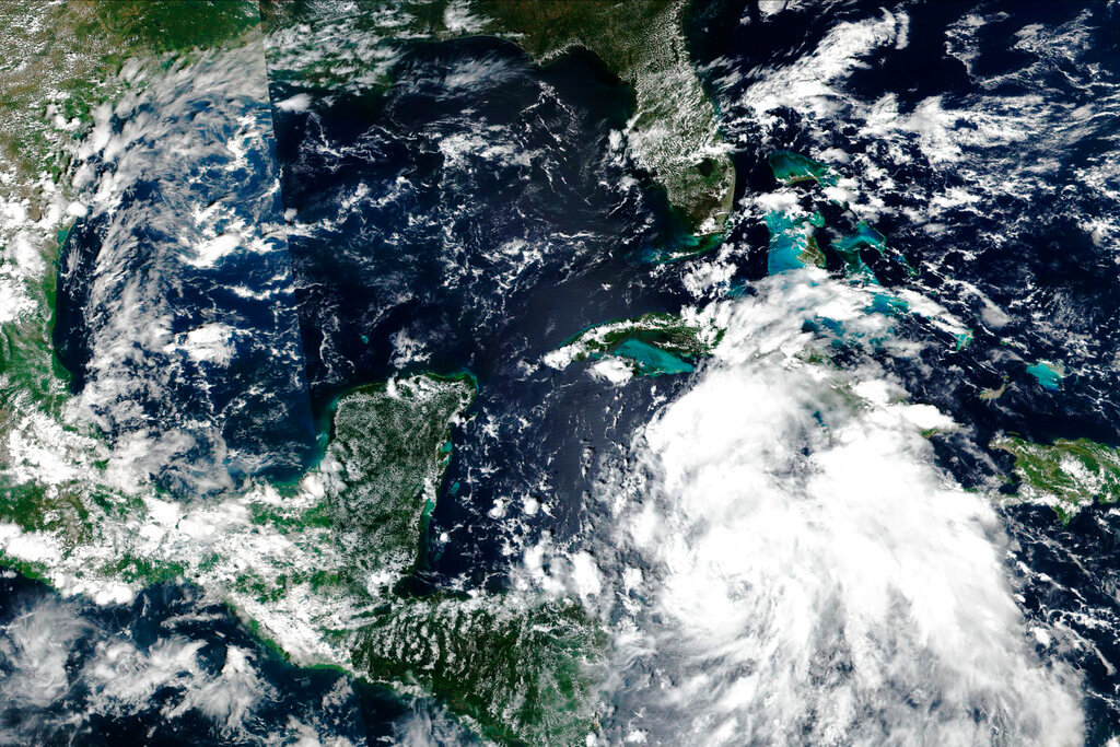 This Sept. 25, 2022 satellite image released by NASA shows Hurricane Ian over Caribbean Sea moving near the Cayman Islands and closer to western Cuba. (EOSDIS via AP)
