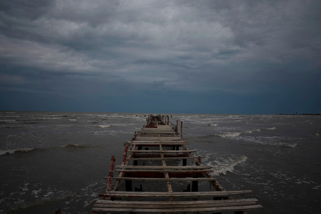 Waves kick up under a dark sky along the shore of Batabano, Cuba, Monday, Sept. 26, 2022. (AP Photo/Ramon Espinosa)