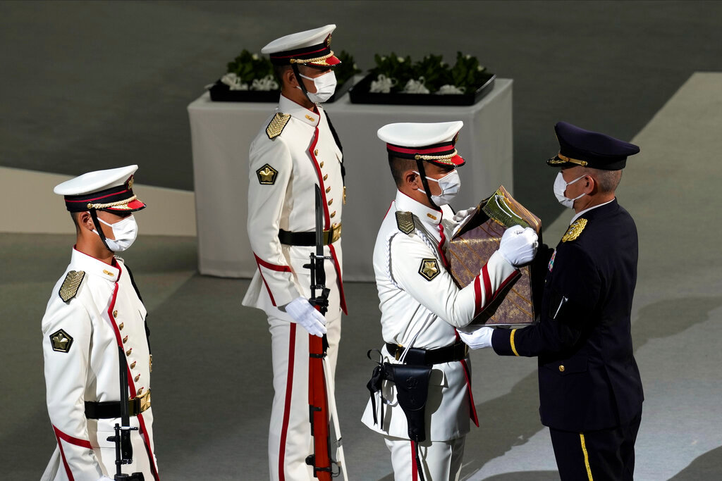 Color guards carry the remains of former Prime Minister of Japan Shinzo Abe during the state funeral Tuesday Sept. 27, 2022, in Tokyo. (AP Photo/Eugene Hoshiko, Pool)