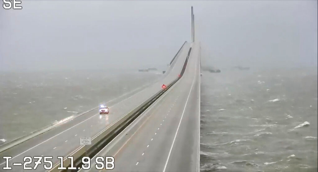 This image provided by FLDOT shows an emergency vehicle traveling on the Sunshine Skyway over Tampa Bay, Fla., on Wednesday, Sept. 28, 2022. (FDOT via AP)