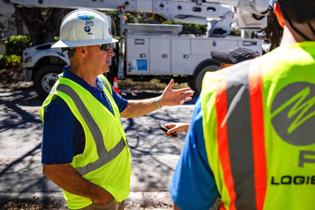 Florida Power and Light CEO Eric Silagy visits workers restoring power in Naples, Fla., on Monday, Oct. 3, 2022. (AP Photo/Robert Bumsted)