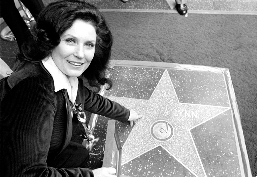 Country music singer Loretta Lynn points to her Hollywood Walk of Fame star during induction ceremonies in Hollywood, Calif., on Feb. 8, 1978. (AP Photo/File)