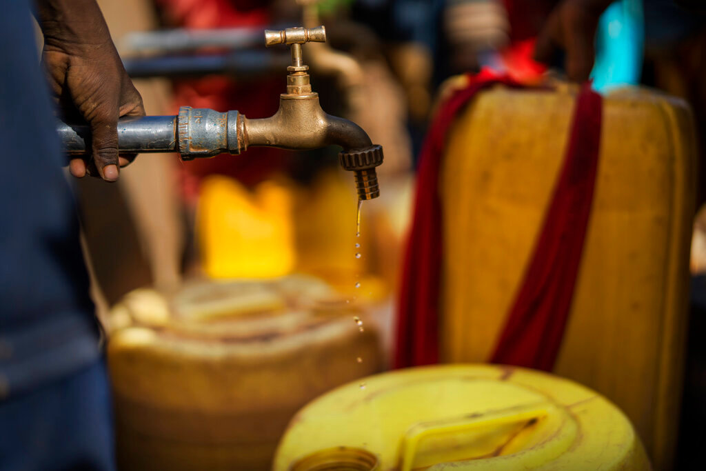 Water dribbles out of a faucet at a camp for displaced people on the outskirts of Dollow, Somalia, Sept. 20, 2022. (AP Photo/Jerome Delay)