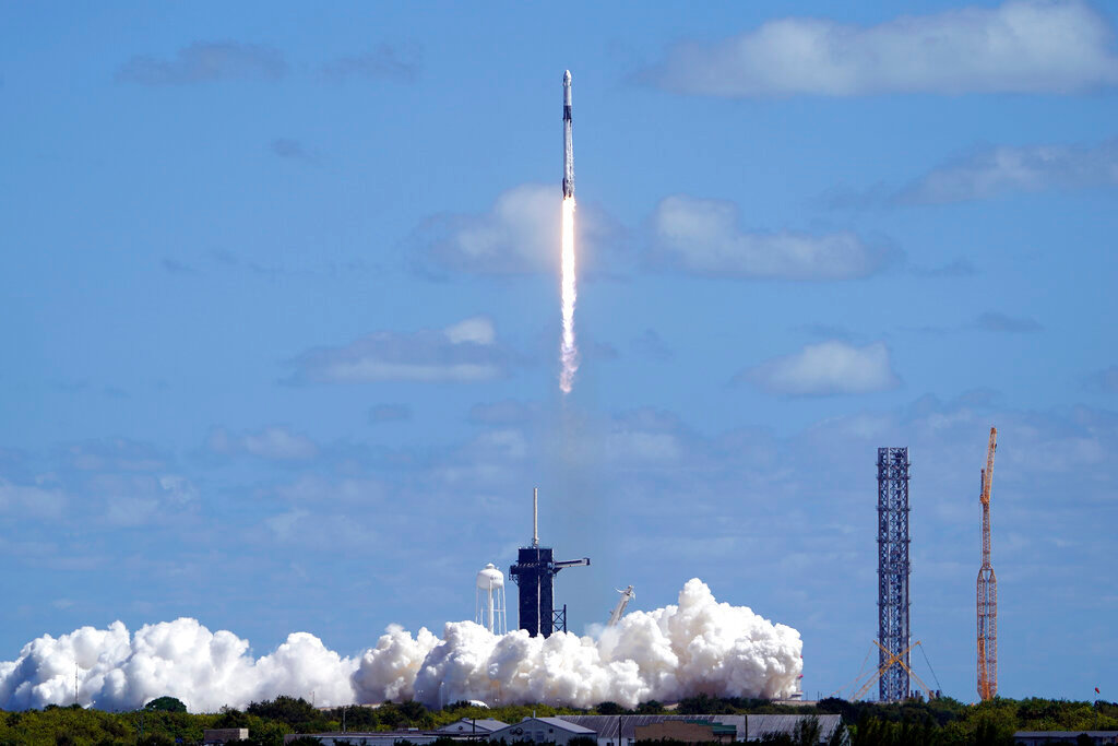 A SpaceX Falcon 9 rocket and the Dragon capsule, with a multinational crew of four astronauts, lifts off from Launch Complex 39-A Wednesday, Oct. 5, 2022, at the Kennedy Space Center in Cape Canaveral, Fla. (AP Photo/John Raoux)