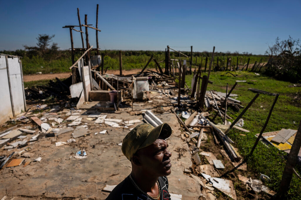Javier Diaz poses for a photo next to his home that was destroyed by Hurricane Ian in La Coloma, in Pinar del Rio province, Cuba, Wednesday, Oct. 5, 2022. (AP Photo/Ramon Espinosa)