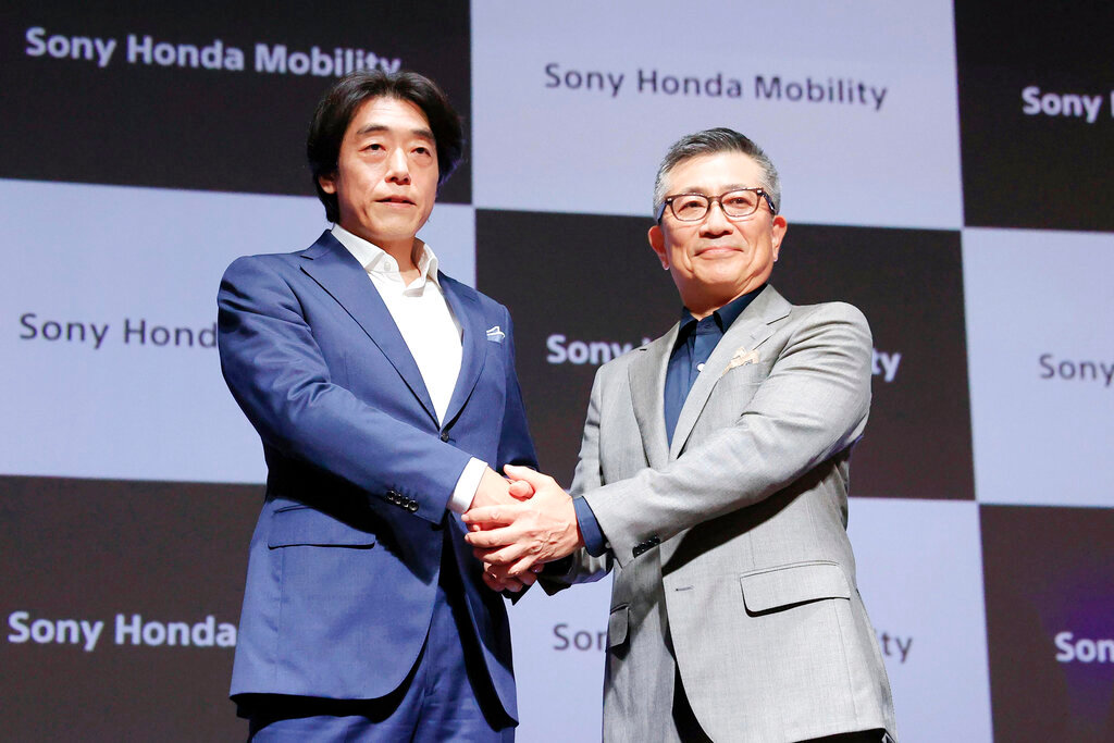 Izumi Kawanishi, left, the Sony executive who became Chief Operating Officer at Sony Mobility and Honda Chief Executive Yasuhide Mizuno pose for a photo during a news conference in Tokyo Thursday, Oct. 13, 2022. (Takuto Kaneko/Kyodo News via AP)